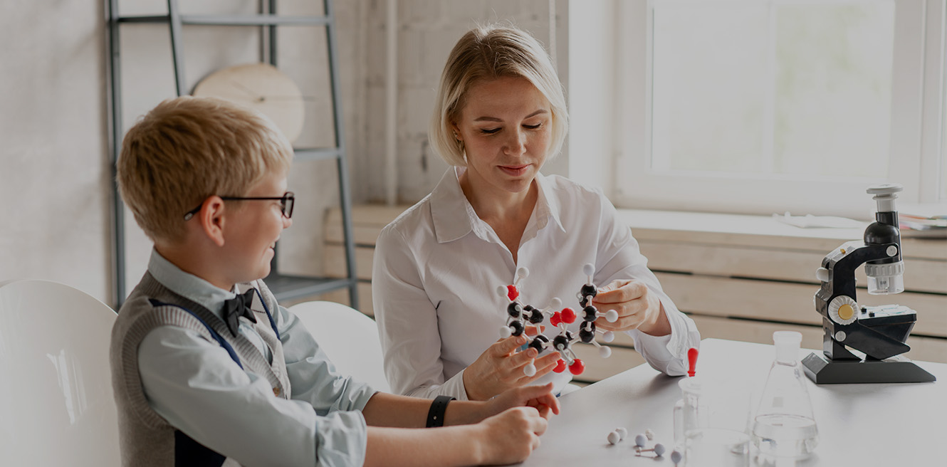 Female science tutor in Fort Lauderdale studying chemistry with student